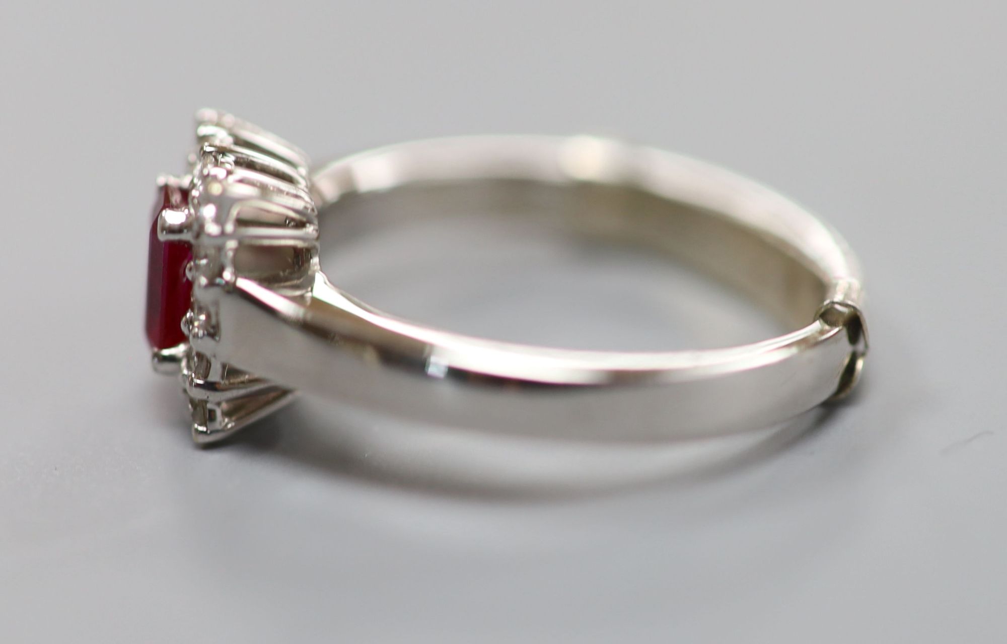 A modern 18ct white gold, ruby and diamond set rectangular cluster ring, size P/Q, gross 6 grams.